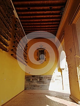 Vertical shot of a cross displayed in the wall of a building in  CÃÂ³rdoba, Spain photo