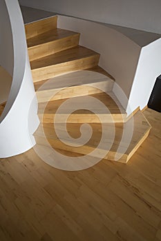 Vertical shot of a curved wooden stairs