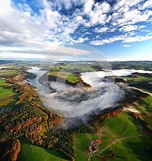 Vertical shot of the Danube curve at sunrise with morning fog