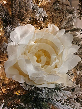 Vertical shot of a decorative white rose on a Christmas tree