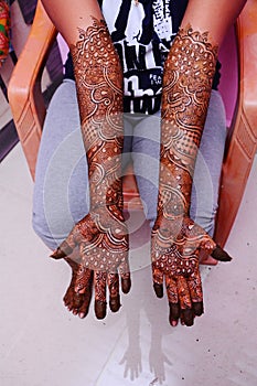 Vertical shot of design of mehndi on female hands