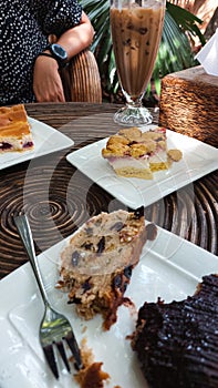 Vertical shot of eating traditional Christstollen and other cakes together at a cafe