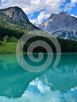 Vertical shot of the Emerald Lake against green mountains in British Columbia, Canada