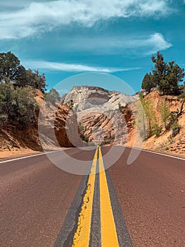 Vertical shot of an empty road between mountains, Bryce Canyon National Park in Utah, United States