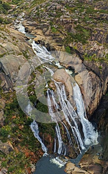 Vertical shot of the Ezaro waterfall in Galicia, Spain photo