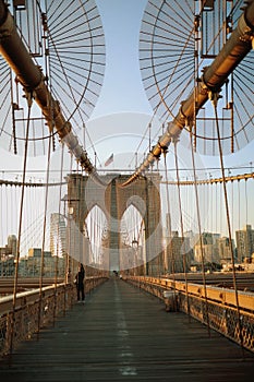 Vertical shot of the famous Brooklyn Bridge in New York City, in warm sunlight