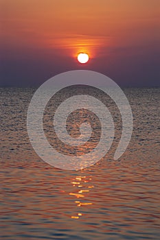 Vertical shot of a fiery sunset taken whilst sailing.