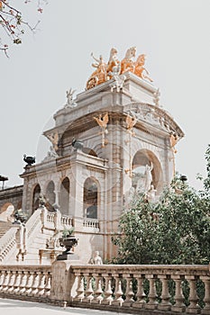 Vertical shot of a fountain and a statue at Parc de la Ciutadella park in Barcelona photo