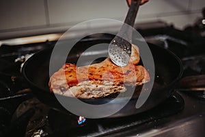 Vertical shot of frying steak in a pan