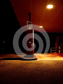 Vertical shot of a fuel dispenser at an empty gas station at night