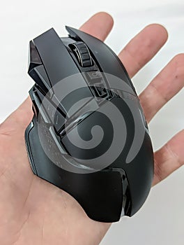 Vertical shot of a gaming mouse on a hand on a white background