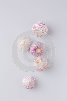 Vertical shot of garlic on a white background