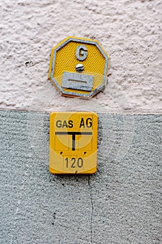 Vertical shot of a gas panel on the wall with the marking of a gas pipeline in Konstanz, Germany