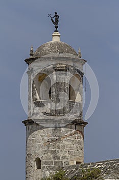 Vertical shot of the Giraldilla de la Habana on the tower of the Castillo de la Real Fuerza, Cuba. photo