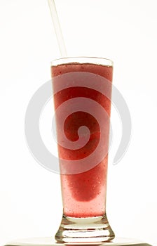 Vertical shot of a glass of delicious red iced drink isolated on a white background