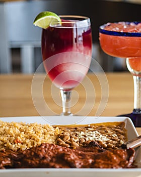 Vertical shot of glasses of iced drinks and a dish on a wooden table