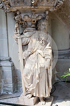 Vertical shot of a God statue with a sword and angels in Magdeburg`s cathedral