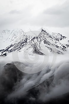 Vertical shot of Gonggar Mountain covered in the snow in Kangding, China