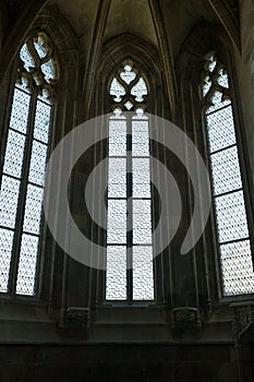 Vertical shot of gothic-style windows of an old church