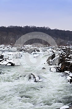 Vertical Shot of Great Falls in the Winter with Snow Covered Rocks