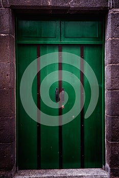 Vertical shot of a green door of an old building in Teror, Gran Canaria, Spain