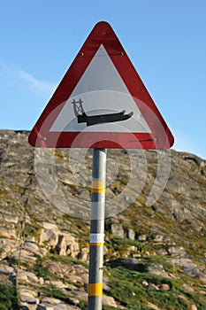 Vertical shot of Greenlandic traffic warning sign