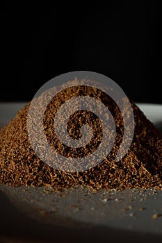 Vertical shot of a ground cardamom on black background