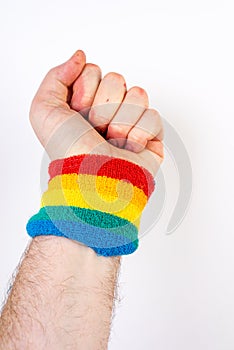 Vertical shot of a hand with a rainbow colored sweatband