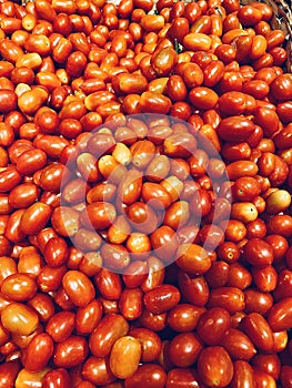 Vertical shot of a heap of fresh ripe red tomatoes