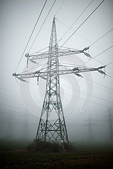 Vertical shot of a high voltage wiring in the fog