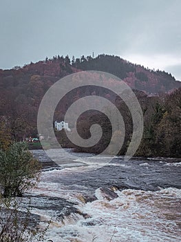 Vertical shot of a hill with lush vegetation and River Dee . Llangollen, Denbighshire, Wales.