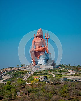 Vertical shot of the historic red Shiva Statue in Nathdwara, India