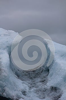 Vertical shot of a hole on the ice in Jokulsarlon, a glacial lake in Iceland.