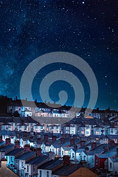 Vertical shot of houses under a bright starry sky at night in Plymouth in the UK