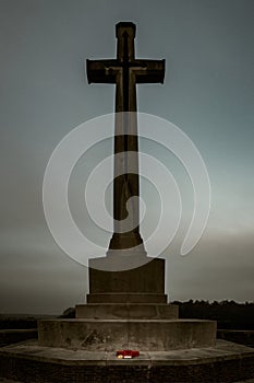 Vertical shot of a huge cross-shaped monument in the Canadian War Cemetery in Groesbeek