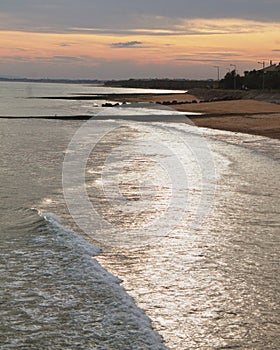 Vertical shot of an idyllic sandy beach at sunset