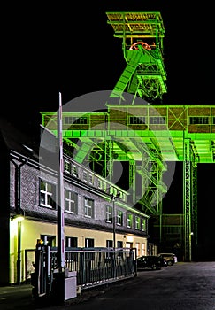 Vertical shot of the illuminated winding tower of the Georg mine in Willroth, Germany at night
