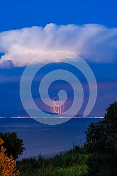 Vertical shot of an incoming storm at the city of Dikili, Turkey as seen from Lesvos, Greece