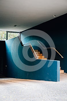 Vertical shot of indoor stairs and blue walls in a modern building