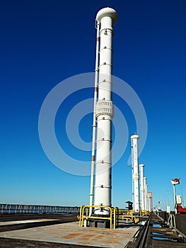 Vertical shot of an industrial chimney against a blue sky