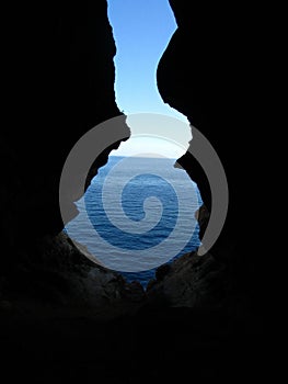 Vertical shot from the inside of the entrance of Ghar in-Naghag cave in Maltese Islands, Malta photo