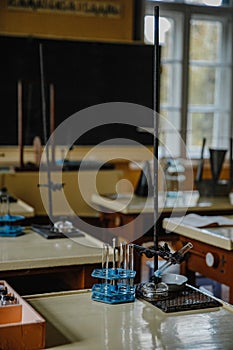 Vertical shot of an interior of an old empty chemistry class laboratory desk in a school