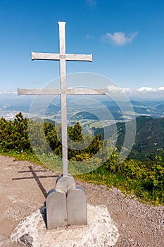 Vertical shot of iron cross on the top of Suchy vrch mountain, Mala Fatra national park, Slovakia. Hot day of summer