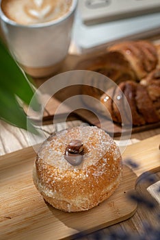Vertical shot of an Italian bombolone donut filled with chocolate, hazelnut on the top