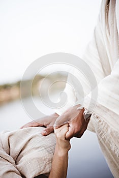 Vertical shot of Jesus Christ healing the female with a blurred background