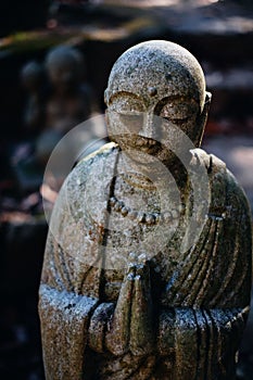 Vertical shot of a Jizo statue in the Buddhist Mitaki-Dera temple in Hiroshima, Japan