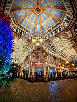 Vertical shot of the Leadenhall market on Christmas week with a decorated tree in London, UK.