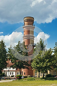 Vertical shot of the Leuchtturm Travemunde brick lighthouse against a blue sky in Lubeck, Germany