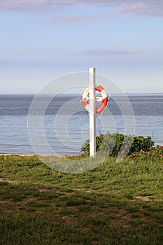 Vertical shot of a Lifebuoy hanging on a pillar in Oesterstrand, Fredericia, Denmark