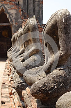 Vertical shot of a line of headless statues at Wat Chai Watthanaram temple, Ayutthaya, Thailand
